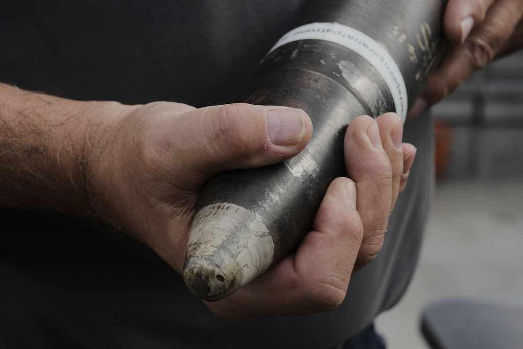 A man of an ammunition recovery service shows a 78 millimetre artillery grenade as an example during a press tour to show the recovering of ammunition from World War II in the Baltic Sea, in Boltenhagen, Germany, Monday, Sept. 1, 2025. (AP Photo/Markus Schreiber)