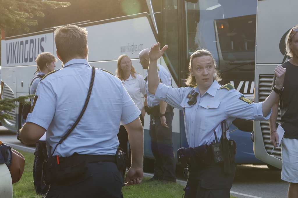 Danish police guide people who were involved in a passenger train derailment at the village of Bjerndrup between Kliplev and Tinglev in Southern Jutland, Denmark, Friday Aug. 15, 2025. (Robert Wengler/Ritzau Scanpix via AP)