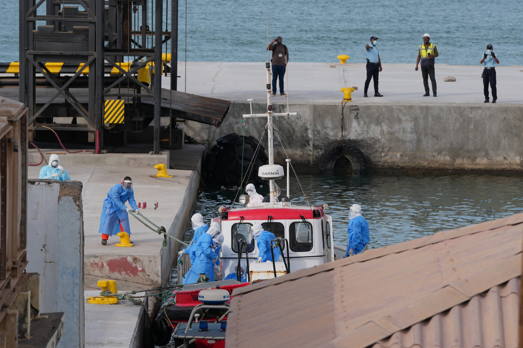 Health workers in protective gear evacuate patients from the MV Hondius cruise ship at a port in Praia, Cape Verde, Wednesday, May 6, 2026. (AP Photo/Misper Apawu)