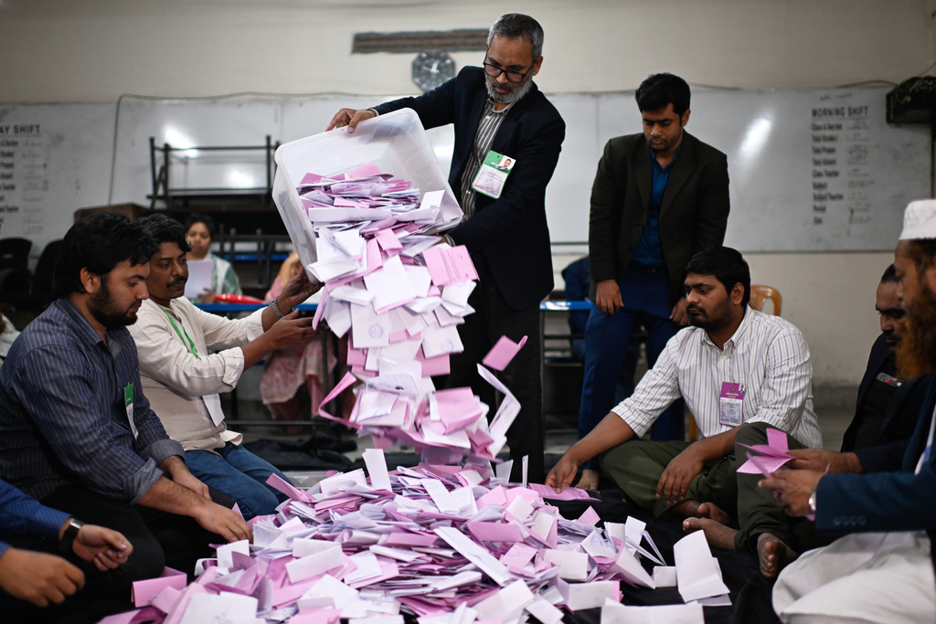 Polling officials begin the counting of votes cast for the national parliamentary election in Dhaka, Bangladesh, Thursday, Feb. 12, 2026. (AP Photo/Mahmud Hossain Opu)