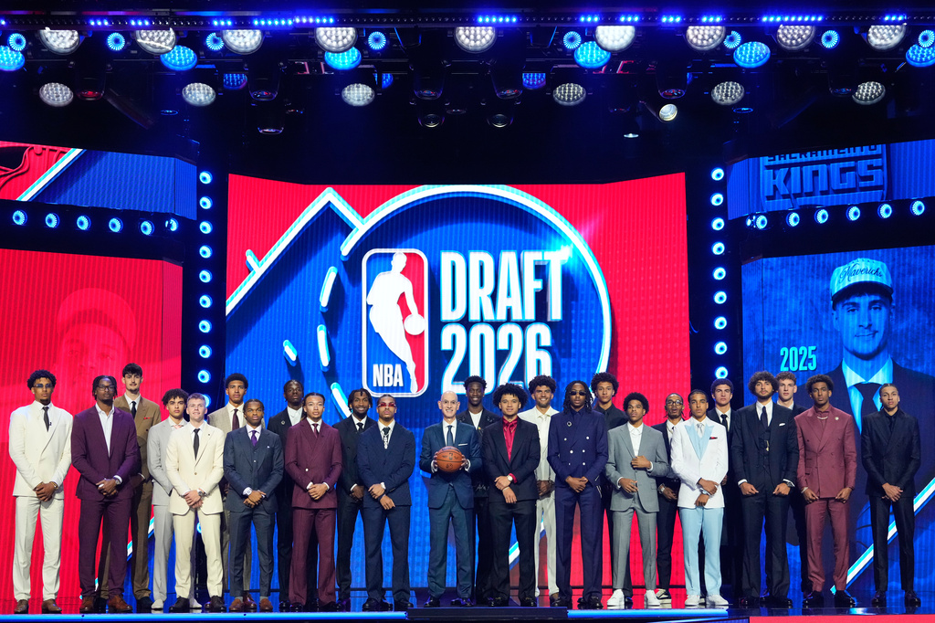 Prospective draftees pose for a group photo with NBA Commissioner Adam Silver, center, before the first round of the NBA basketball draft, Tuesday, June 23, 2026, in New York. (AP Photo/Yuki Iwamura)