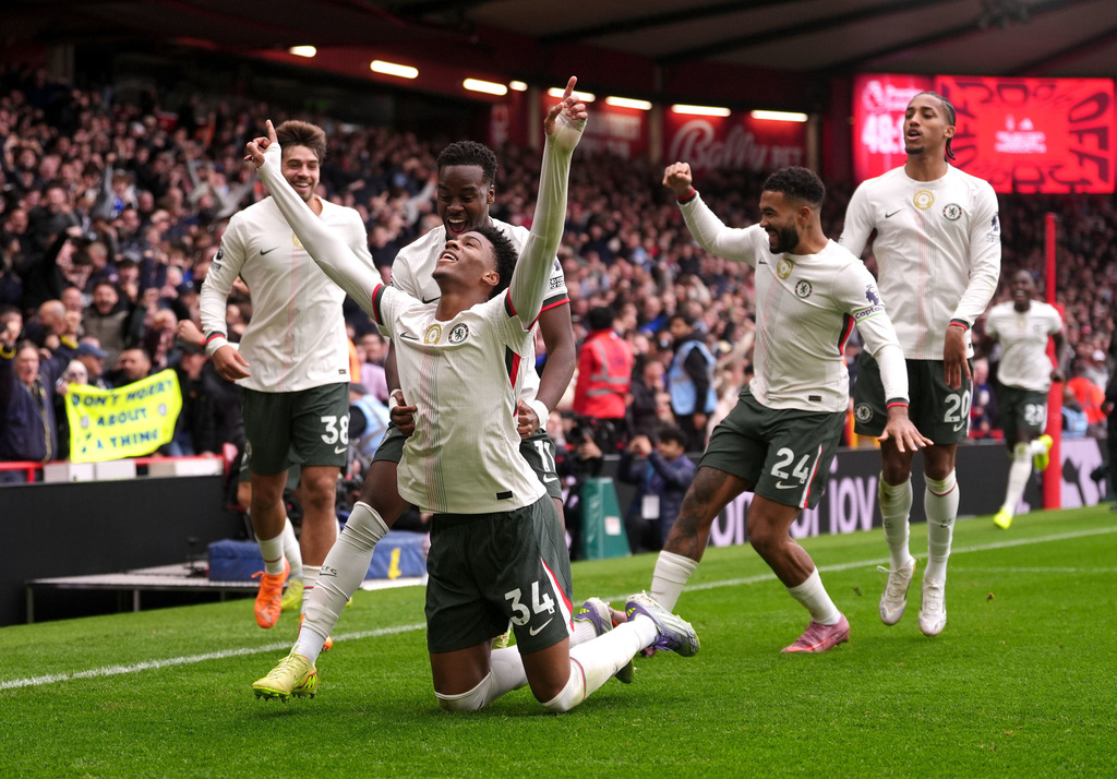 Chelsea's Josh Acheampong celebrates scoring the opening goal with teammates, during the English Premier League soccer match between Nottingham Forest and Chelsea, in Nottingham, England, Saturday, Oct. 18, 2025. (Bradley Collyer/PA via AP)
