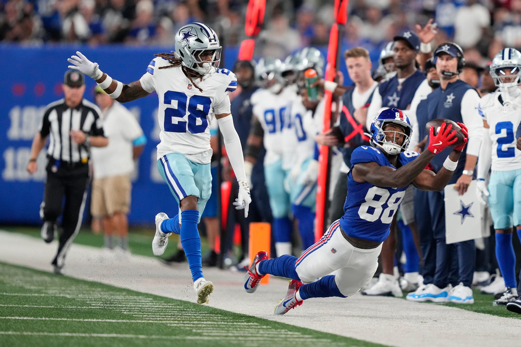 New York Giants wide receiver Malachi Fields (88) attempts but is unable to make a catch in front of Dallas Cowboys cornerback Shavon Revel Jr. (28) during the first half of an NFL football game Sunday, Sept. 13, 2026, in East Rutherford, N.J. (AP Photo/Yuki Iwamura)
