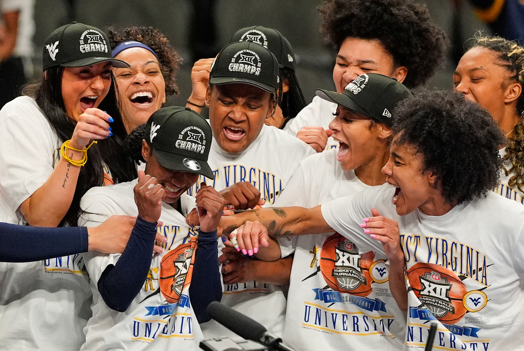 West Virginia players celebrate after winning their NCAA college basketball championship game against TCU at the Big 12 Conference tournament Sunday, March 8, 2026, in Kansas City, Mo. (AP Photo/Charlie Riedel)