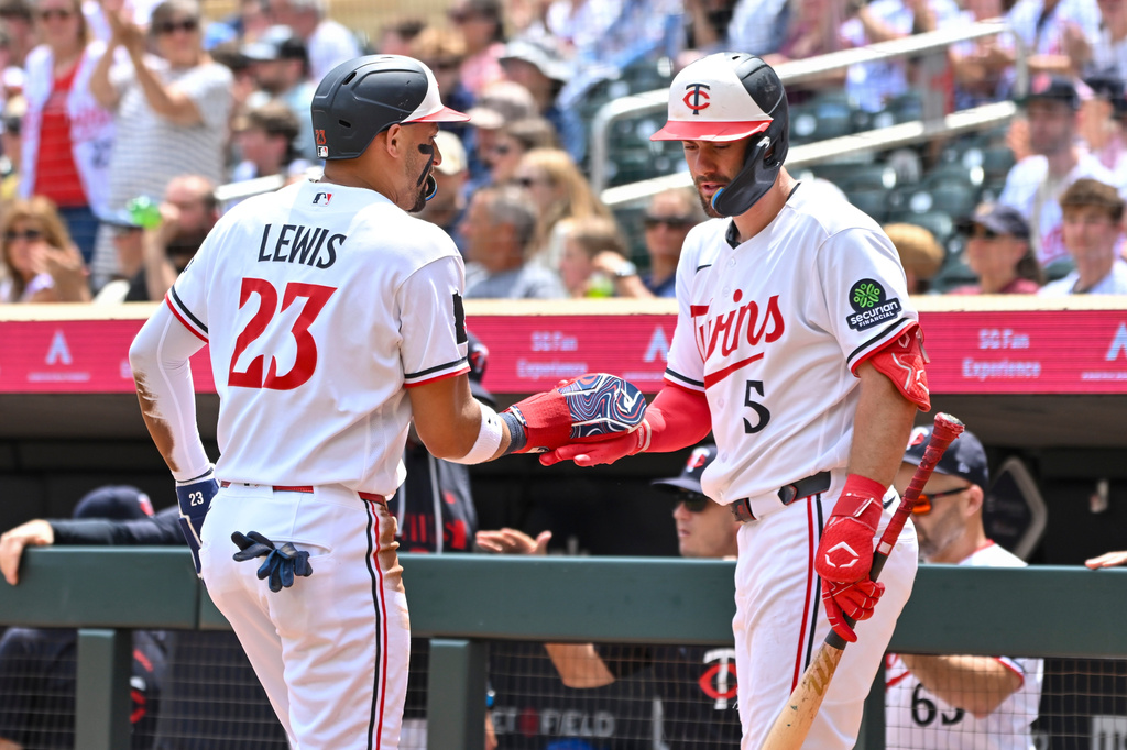 Minnesota Twins' Royce Lewis (23) celebrates with Ryan Kreidler (5) after scoring against the Colorado Rockies during the second inning of a baseball game Sunday, June 28, 2026, in Minneapolis. (AP Photo/Craig Lassig)