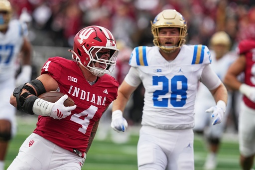 Indiana linebacker Aiden Fisher (4) runs back an interception for a touchdown during the first half of an NCAA college football game against UCLA, Saturday, Oct. 25, 2025, in Bloomington, Ind. (AP Photo/Darron Cummings) Indiana linebacker Aiden Fisher (4) runs back an interception for a touchdown during the first half of an NCAA college football game against UCLA, Saturday, Oct. 25, 2025, in Bloomington, Ind. (AP Photo/Darron Cummings)