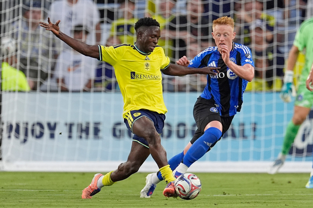Nashville SC midfielder Shakur Mohammed, left, moves the ball past CF Montréal midfielder Matthew Longstaff, right, during the first half of an MLS soccer match Wednesday, July 22, 2026, in Nashville, Tenn. (AP Photo/George Walker IV)