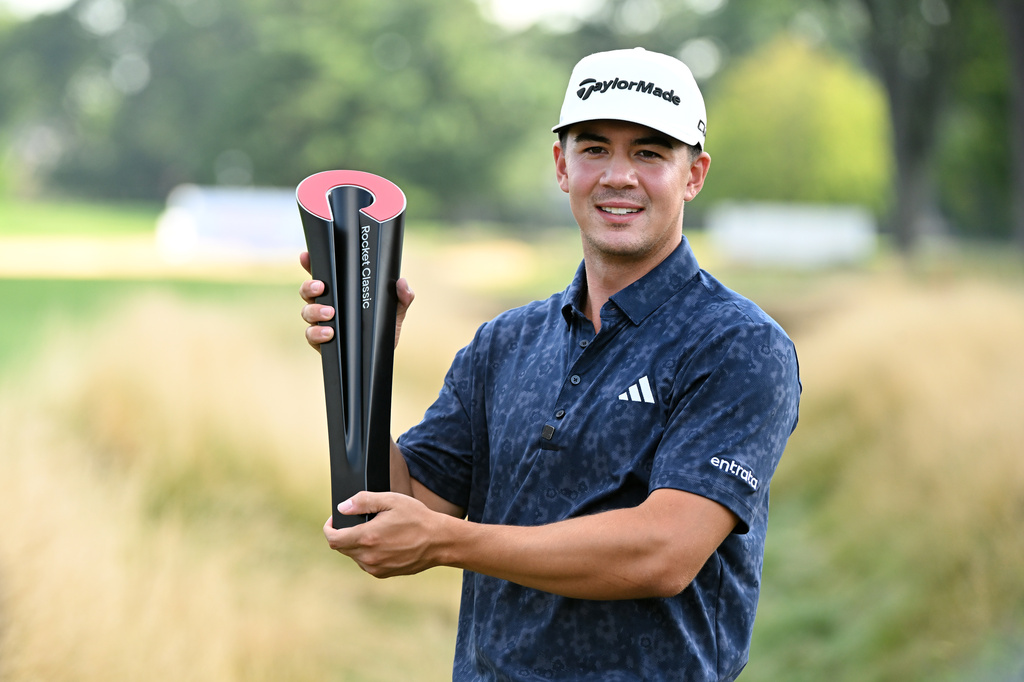 Michael Thorbjornsen poses with the trophy after winning the Rocket Classic golf tournament, Sunday, Aug. 2, 2026, in Detroit. (AP Photo/Jose Juarez)
