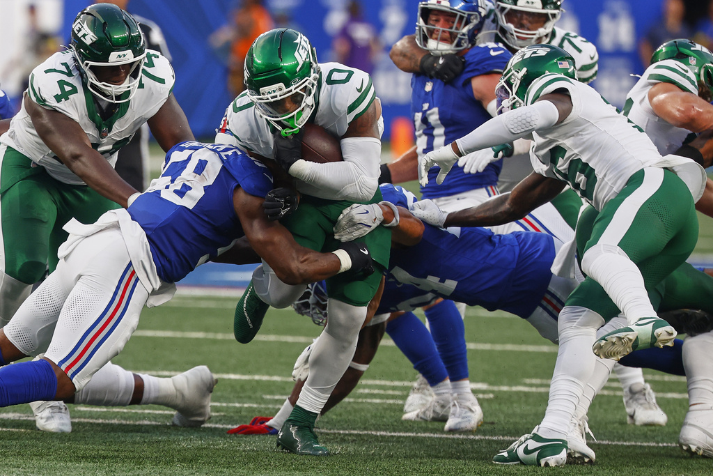 New York Jets running back Braelon Allen (0) carries the ball against the New York Giants during the first quarter of an NFL football game, Saturday, Aug. 16, 2025, in East Rutherford, N.J. (AP Photo/Noah K. Murray)