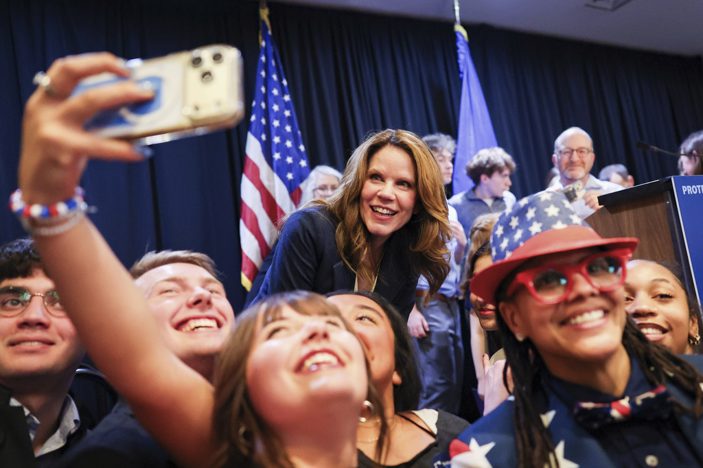 Wisconsin State Supreme Court Justice-elect Chris Taylor takes a picture with constituents after speaking on Tuesday, April 7, 2026, in Madison, Wis. (Owen Ziliak/Wisconsin State Journal via AP)