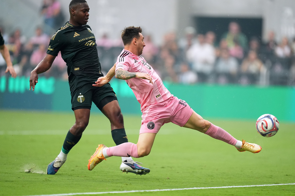 Inter Miami midfielder Leo Messi shoots past Portland Timbers defender Kamal Miller during the first half of an MLS soccer match, Sunday, May 17, 2026, in Miami. (AP Photo/Rebecca Blackwell)