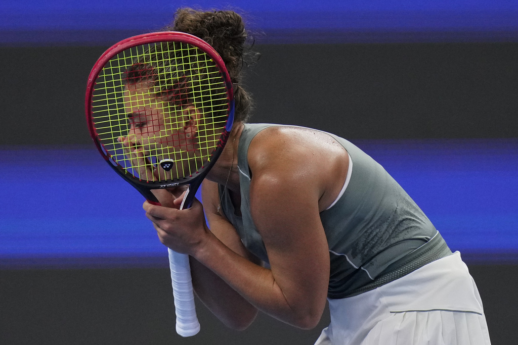 Italy's Jasmine Paolini reacts after losing a point to Amanda Anisimova, of the United States during the women's singles quarterfinals match of the China Open tennis tournament, at the National Tennis Center, in Beijing, Thursday, Oct. 2, 2025. (AP Photo/Andy Wong)