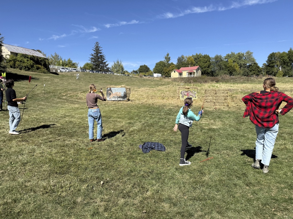 Competitors practice throwing an atlatl at painted animal targets during the Northeastern Atlatl Championship in Addison, Vt. on Saturday, Sept. 20, 2025. (AP Photo/Amanda Swinhart)