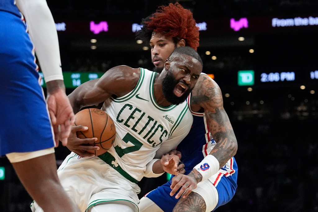Boston Celtics guard Jaylen Brown (7) drives against Philadelphia 76ers guard Kelly Oubre Jr. (9) during the first half in Game 1 of a first-round NBA playoffs basketball game, Sunday, April 19, 2026, in Boston. (AP Photo/Robert F. Bukaty)
