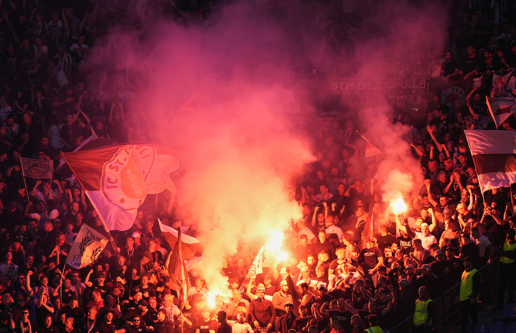 St. Pauli fans set off fireworks in the stands during the German Bundesliga soccer match between Hamburger SV and FC St. Pauli at Volksparkstadion in Hamburg, Germany, Friday, Aug. 29, 2025. (Marcus Brandt/dpa via AP)