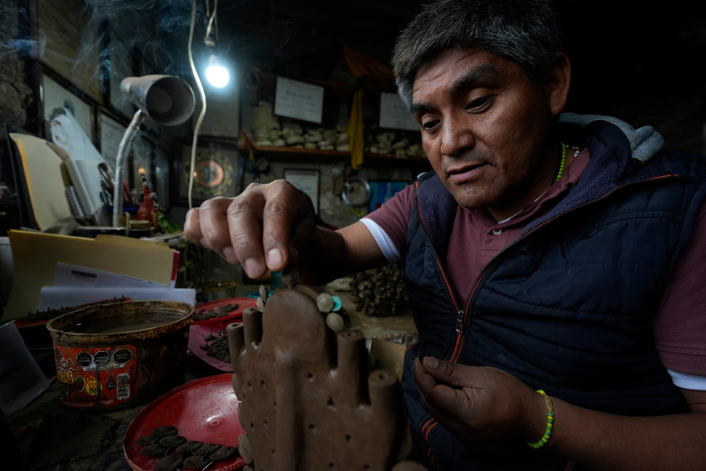Mexican craftsman Hilario Hernandez works in a fragile clay piece at his atelier in Metepec, Mexico, Thursday, Oct. 9, 2025. (AP Photo/Fernando Llano)