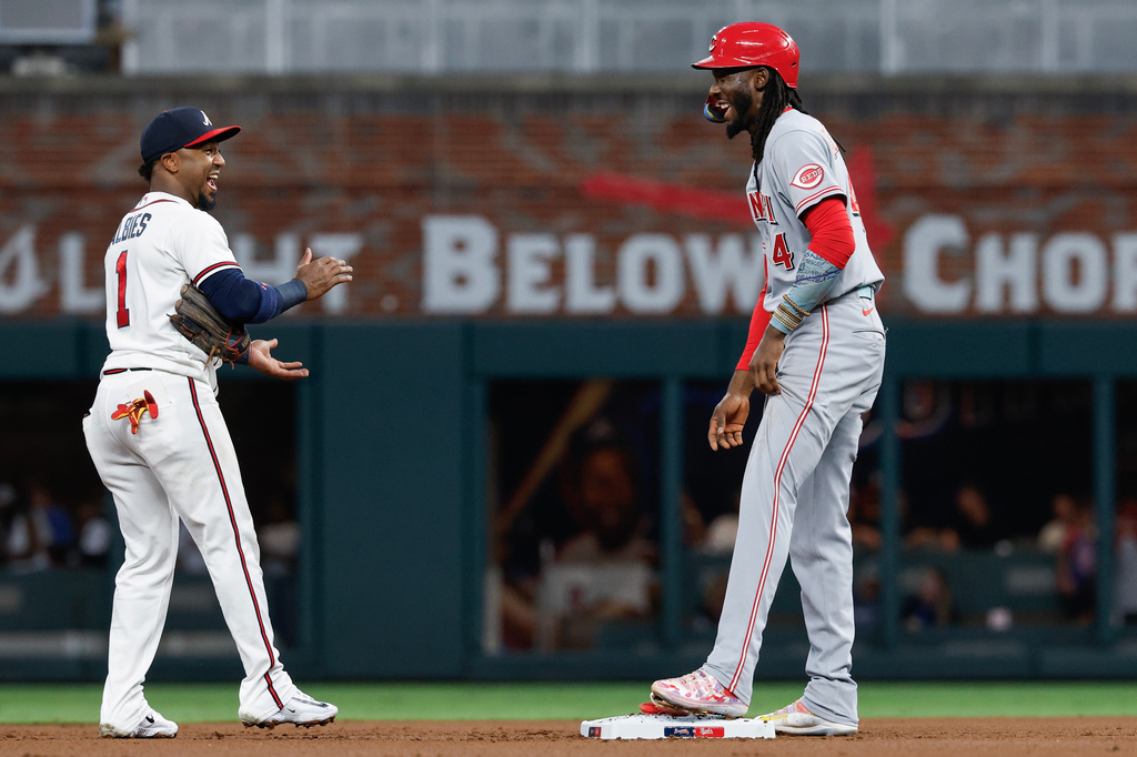 Cincinnati Reds' Elly De La Cruz (44) jokes with Atlanta Braves second baseman Ozzie Albies (1) during a replay challenge of De La Cruz's steal of second base in the first inning of a baseball game, Tuesday, Sept. 22, 2026, in Atlanta. (AP Photo/Erik S. Lesser)