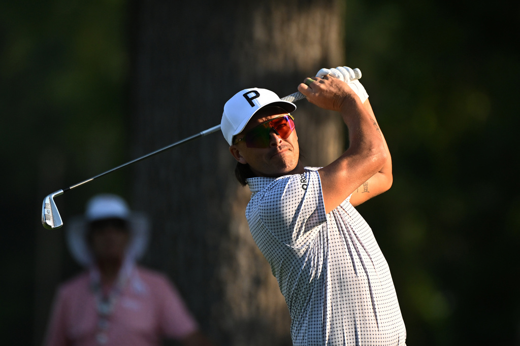 Rickie Fowler hits from the 11th tee during the first round of the Rocket Classic golf tournament at the Detroit Golf Club, Thursday, July 30, 2026, in Detroit. (AP Photo/Jose Juarez)