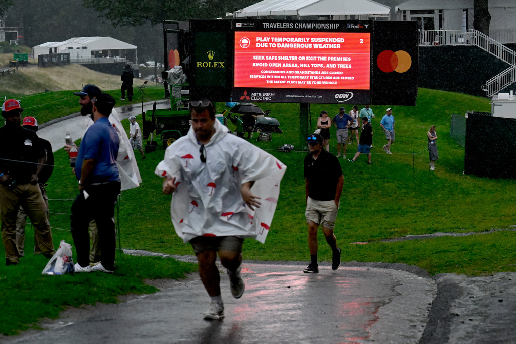 A sign announces that play is temporarily suspended due to dangerous weather during the final round of the Travelers Championship golf tournament at TPC River Highlands, Sunday, June 28, 2026, in Cromwell, Conn. (AP Photo/Jessica Hill)