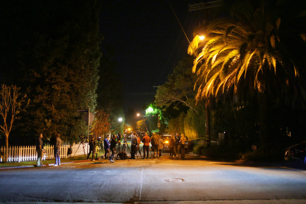 News media gather near Rob Reiner's residence Sunday, Dec. 14, 2025, in the Brentwood section of Los Angeles. (AP Photo/Ethan Swope)