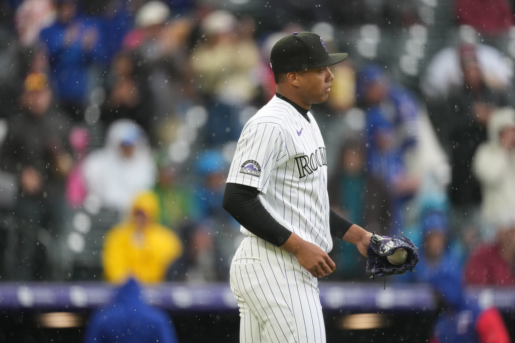 Colorado Rockies relief pitcher Juan Mejia reacts after giving up the go-ahead run to Texas Rangers' Josh Jung on an RBI single in the ninth inning of a baseball game Wednesday, May 20, 2026, in Denver. (AP Photo/David Zalubowski)