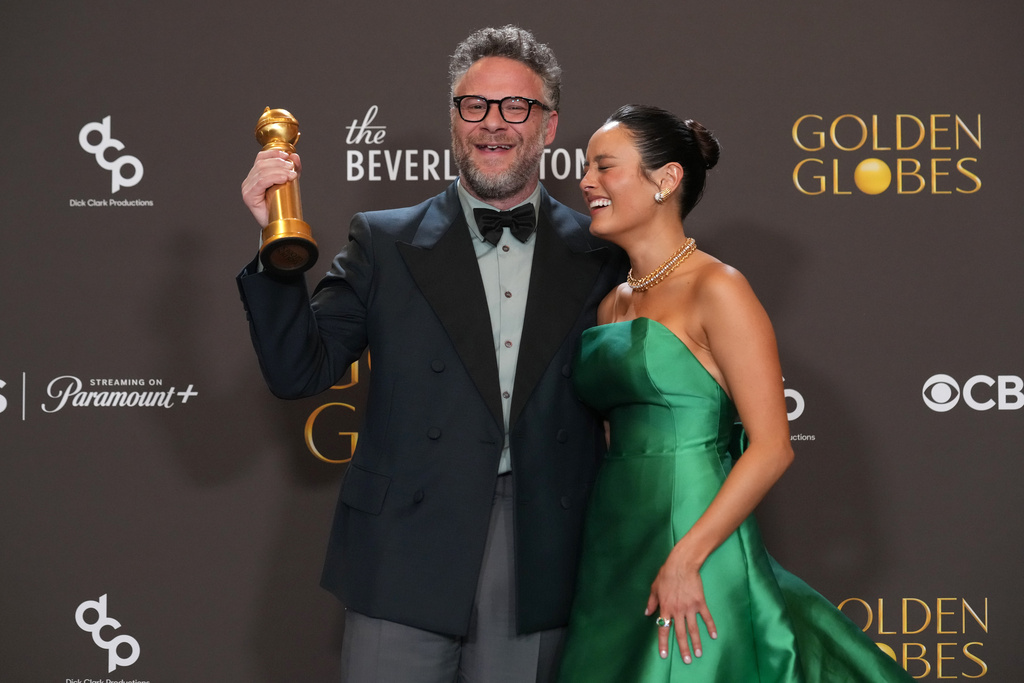 Seth Rogen, left, and Chase Sui Wonders pose in the press room with the award for best television series – musical or comedy for "The Studio" during the 83rd Golden Globes on Sunday, Jan. 11, 2026, at the Beverly Hilton in Beverly Hills, Calif. (AP Photo/Chris Pizzello)