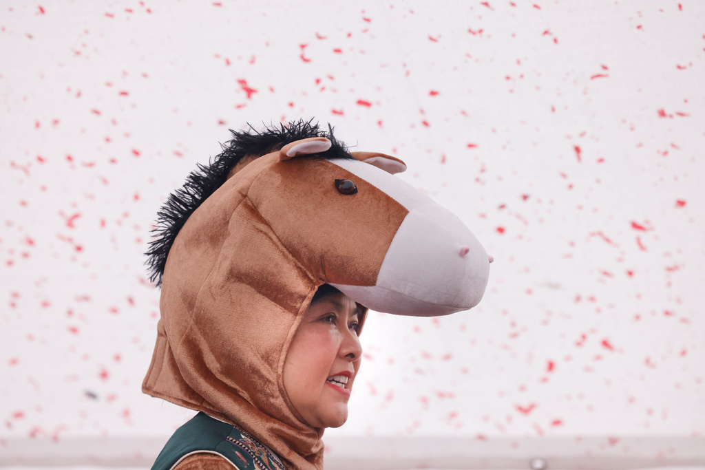 Rose Chung, MC of the annual Chinese New Year Day celebration, Community Good Fortune Walk, on Grant Avenue, wears a horse costume on the first day of the Chinese New Year, Tuesday, Feb. 17, 2026, in San Francisco. (Lea Suzuki/San Francisco Chronicle via AP)