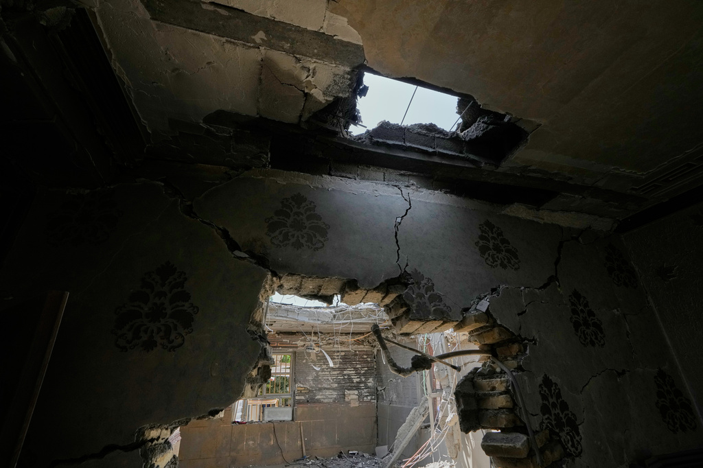 A hole in the ceiling and damaged walls are seen inside a home that Iranian media said was hit by a U.S. strike while a wedding celebration was taking place late Tuesday, Sept. 1, in Kuhestak, southern Iran, Friday, Sept. 4, 2026. (AP Photo/Vahid Salemi)