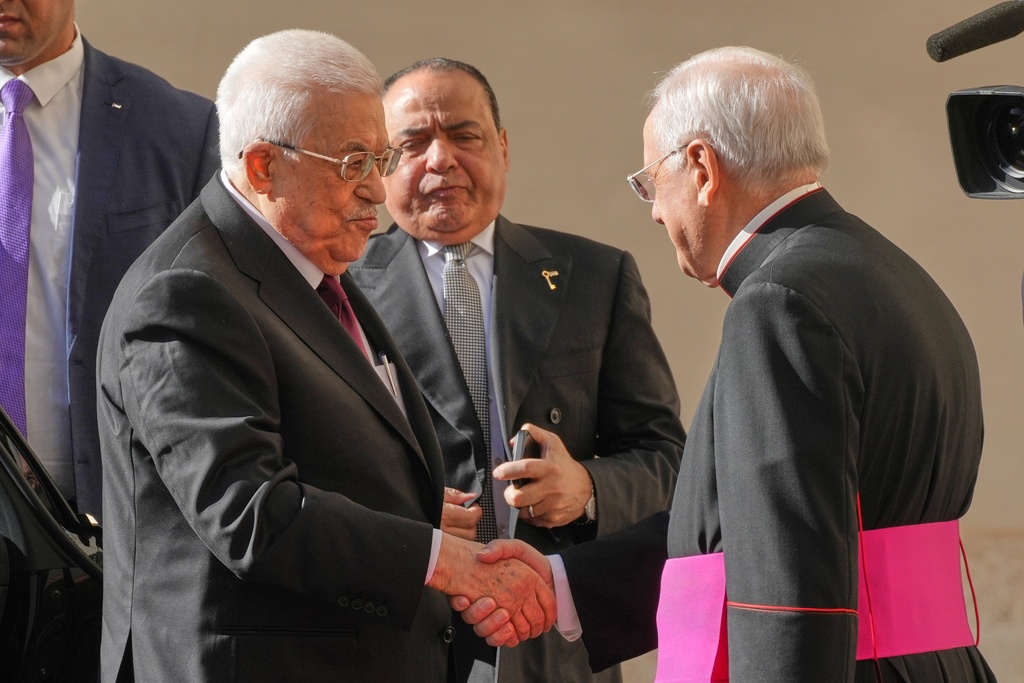Palestinian President Mahmoud Abbas, also known as Abu Mazen, left, is welcomed by Monsignor Leonardo Sapienza as he arrives in the St. Damasus Courtyard at the Vatican for a meeting with Pope Leo XIV, Thursday, Nov. 6, 2025. (AP Photo/Andrew Medichini)