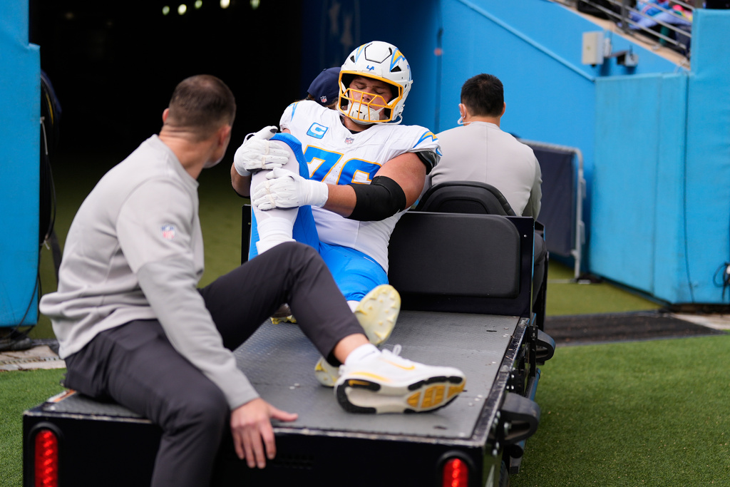 Los Angeles Chargers offensive tackle Joe Alt (76) is carted off the field during the first half of an NFL football game against the Tennessee Titans, Sunday, Nov. 2, 2025, in Nashville, Tenn. (AP Photo/George Walker IV)