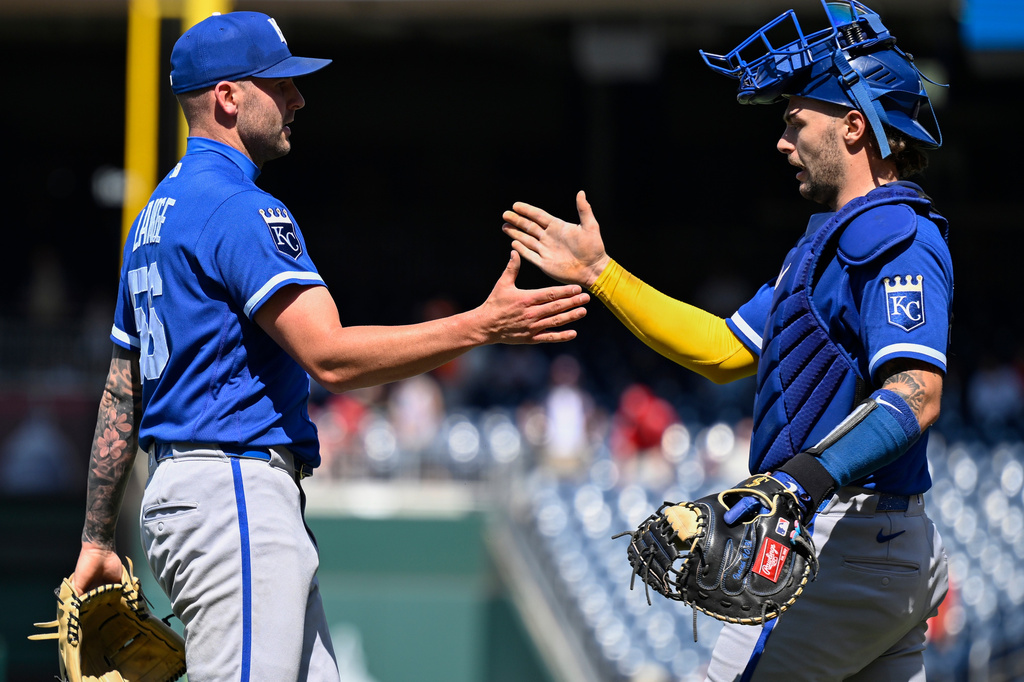 Kansas City Royals closing pitcher Alex Lange, left, is congratulated by Royals catcher Carter Jensen after defeating the Washington Nationals, Wednesday, June 17, 2026, in Washington. (AP Photo/John McDonnell)