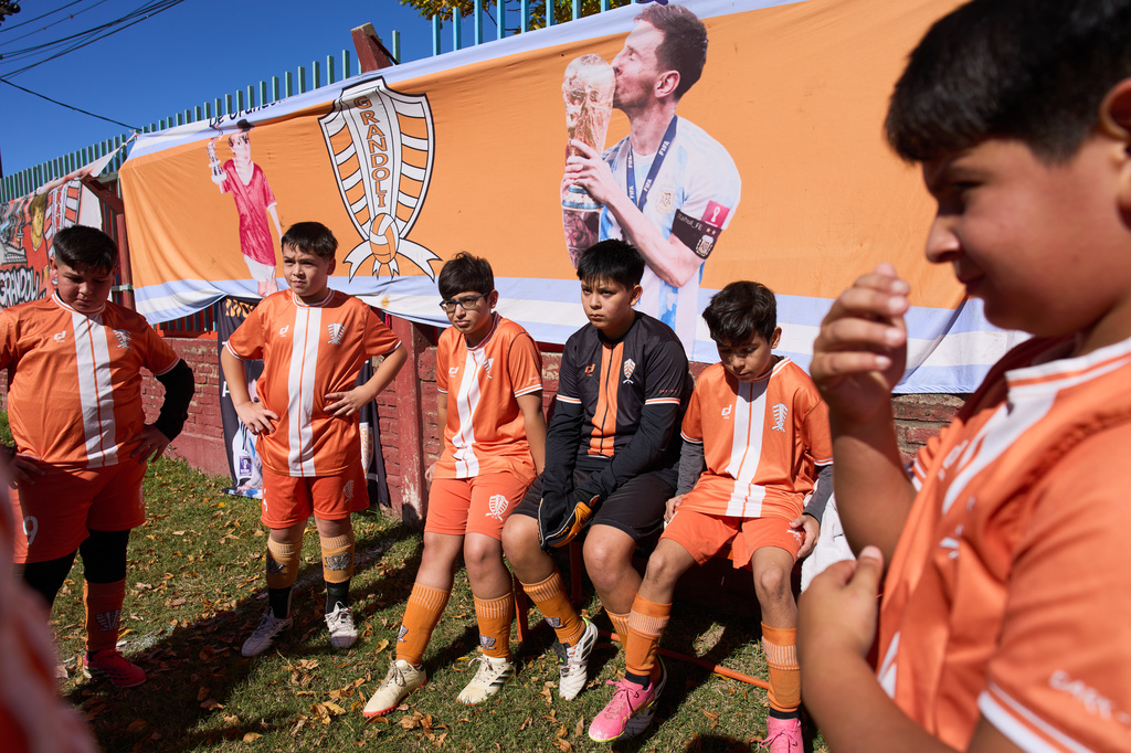 Children from the Grandoli club, where soccer star Lionel Messi played as a child, listen to their coach before the start of a game in Rosario, Argentina, Saturday, May 2, 2026. (AP Photo/Rodrigo Abd)