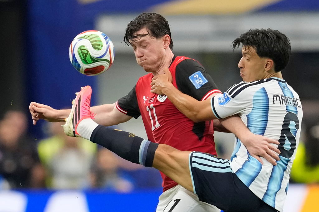 Austria's Michael Gregoritsch (11) and Argentina's Valentin Barco battle for the ball during the World Cup Group J soccer match in Arlington, Texas, near Dallas, Monday, June 22, 2026. (AP Photo/Tony Gutierrez)