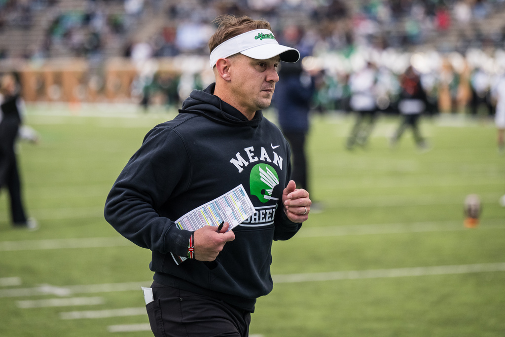 North Texas head coach Eric Morris runs off the field for halftime during an NCAA college football game against Temple, Friday, Nov. 28, 2025, Denton, Texas. (AP Photo/Jessica Tobias)