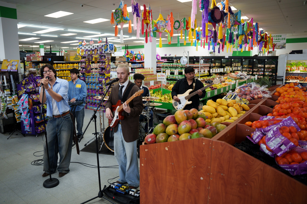 Bilingual alternative pop band Luna Luna performs in the produce section of Fiesta Fresh Market in New Castle, Del., on Sunday, April 26, 2026. (AP Photo/Mingson Lau)