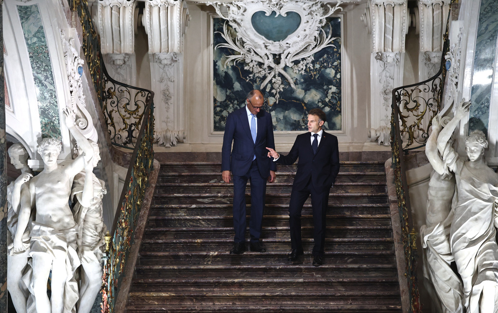 German Chancellor Friedrich Merz, left, talks with French President Emmanuel Macron as they arrive for a press conference following a meeting of the Franco-German Ministerial Council in Brühl, Germany, Friday, July 17, 2026. (Oliver Berg/dpa via AP)