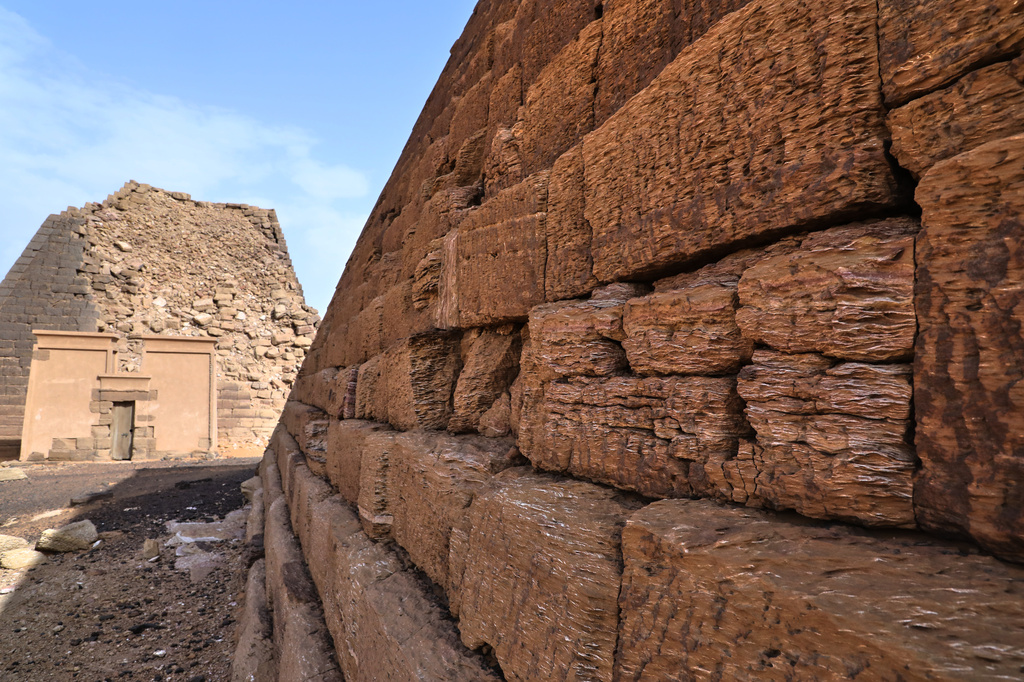 A pyramid's stone blocks stand at the Meroe archaeological site in Bejrawiya, Sudan, Saturday, Aug. 1, 2026. (AP Photo/Mohnd Blal)