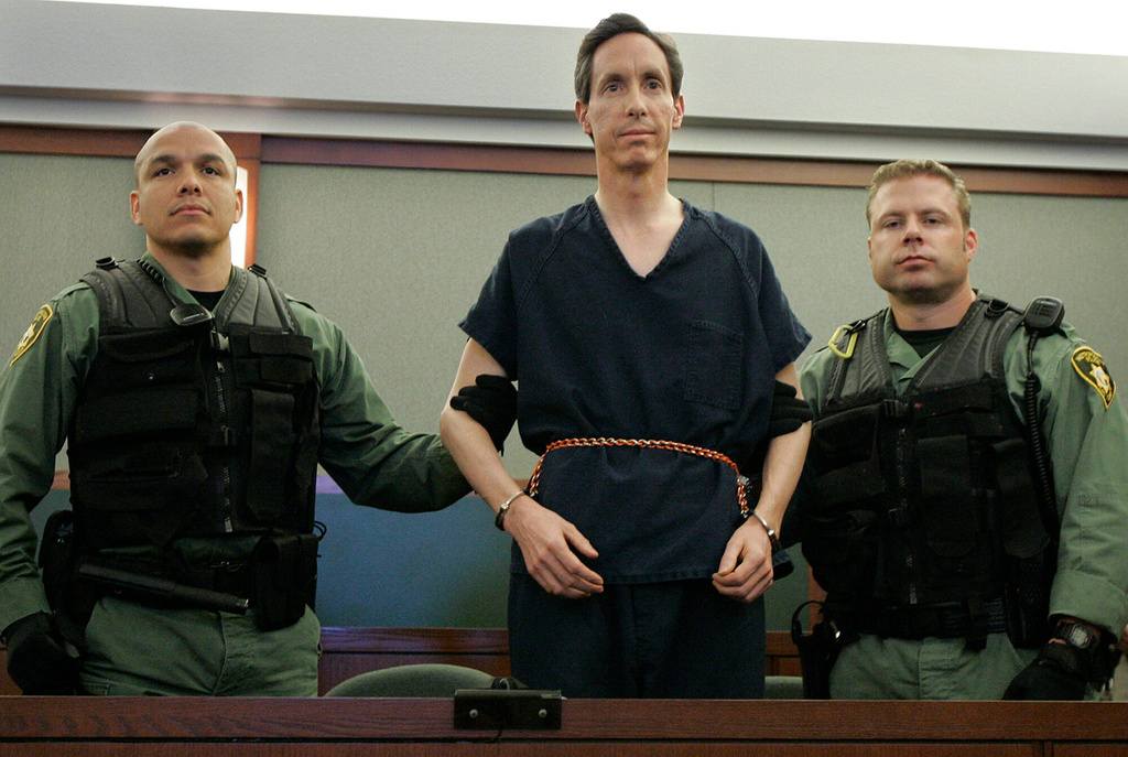 FILE - Warren Jeffs appears in a courtroom surrounded by guards in Las Vegas, on Aug. 31, 2006. (AP Photo/Laura Rauch, File)