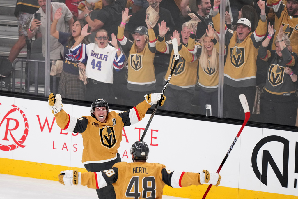 FILE - Vegas Golden Knights right wing Mitch Marner, top, celebrates his goal with center Tomas Hertl during the second period in Game 3 of the NHL hockey Stanley Cup Final series against the Carolina Hurricanes, June 6, 2026, in Las Vegas. (AP Photo/Candice Ward, File)