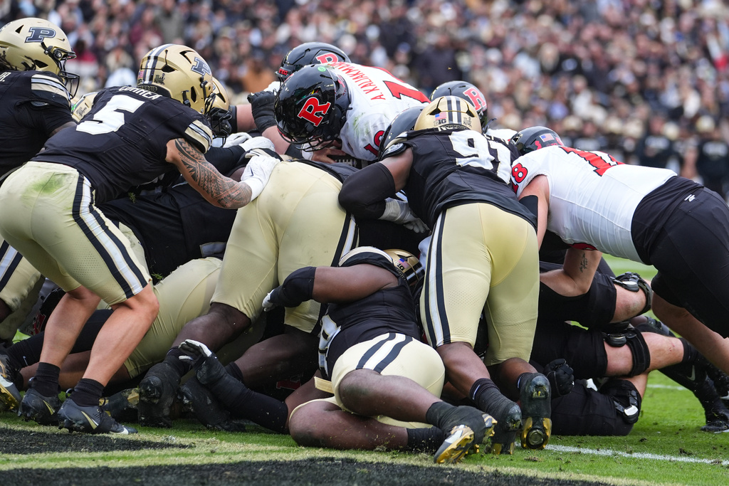 Rutgers quarterback Athan Kaliakmanis (16) runs in for a touchdown against Purdue during the second half of an NCAA college football game in West Lafayette, Ind., Saturday, Oct. 25, 2025. (AP Photo/Michael Conroy)