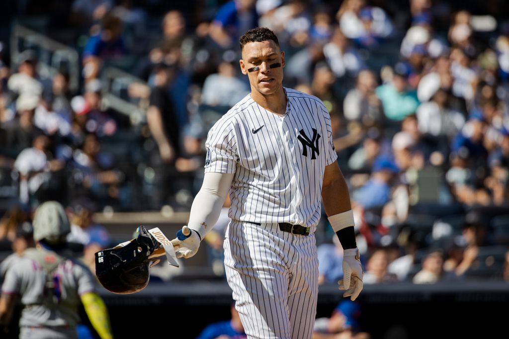 New York Yankees' Aaron Judge removes his batting helmet after striking out during the third inning of a baseball game against the New York Mets, Sunday, Sept. 13, 2026, in New York. (AP Photo/Angelina Katsanis)