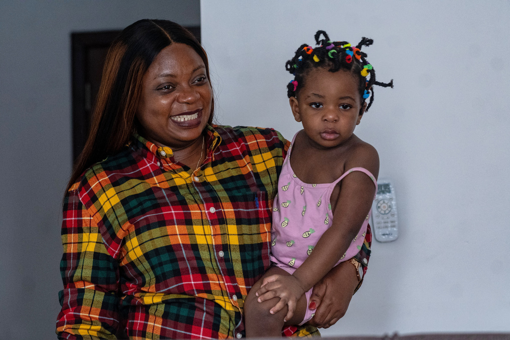 Gloria Masanka, a mother of two daughters, spends time with her younger daughter at home in Kinshasa, Congo, Monday, April 6, 2026. (AP Photo/Samy Ntumba Shambuyi)
