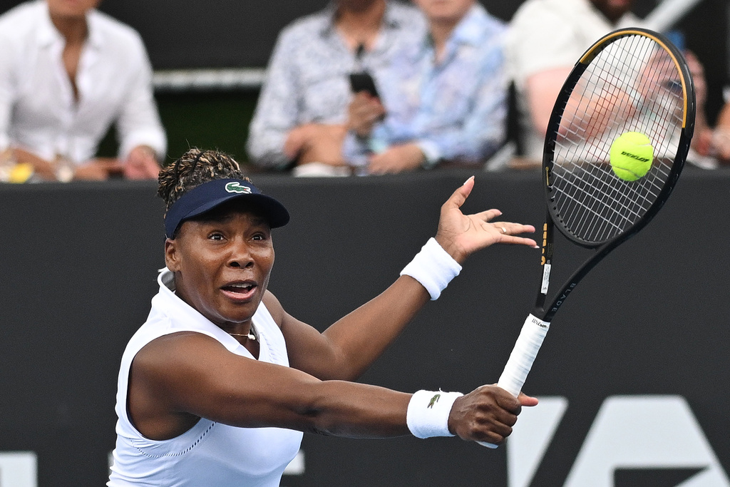 Venus Williams of the U.S. hits a backhand to Magda Linette of Poland during her singles match of the ASB Classic Women's Tennis Tournament in Auckland, New Zealand, Tuesday Jan. 6, 2026. (Andrew Cornaga/Photosport via AP)