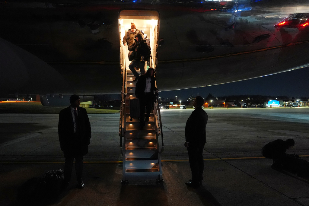 Members of the media exit Air Force One after the plane, carrying President Donald Trump to the World Economic Form in Davos, experienced a minor electrical issue after departure, Tuesday, Jan. 20, 2026, and returned to Joint Base Andrews, Md. Trump will board a second plane to complete the trip. (AP Photo/Evan Vucci)