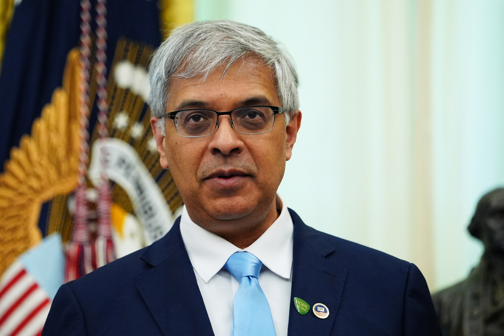National Institutes of Health Director Dr. Jay Bhattacharya listens to President Donald Trump speak in the Oval Office of the White House, Saturday, April 18, 2026, in Washington. (AP Photo/Julia Demaree Nikhinson)