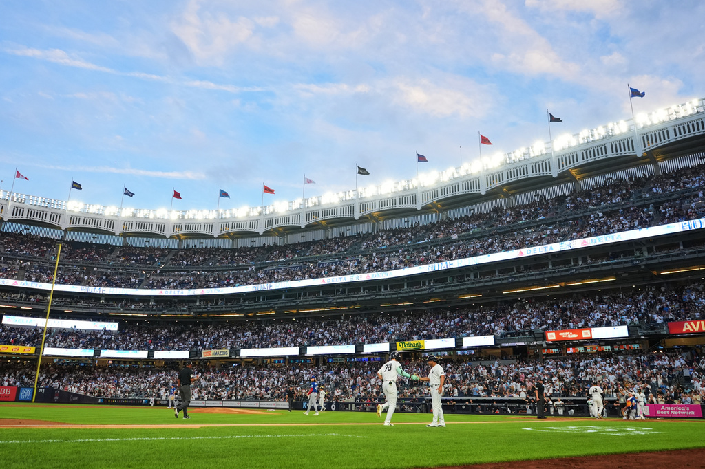 New York Yankees' Spencer Jones celebrates with third base/outfield coach Luis Rojas as he runs the bases after hitting a two-run home run during the second inning of a baseball game against the Toronto Blue Jays Friday, Aug. 21, 2026, in New York. (AP Photo/Frank Franklin II)