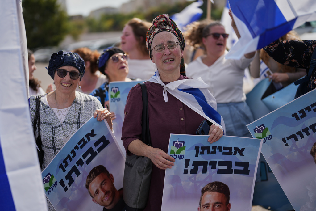 People react as they wait outside Beilinson Hospital in Petah Tikva, Israel, where some of the freed hostages are expected to arrive after being released from Hamas captivity in the Gaza Strip, Monday, Oct. 13, 2025. (AP Photo/Francisco Seco)