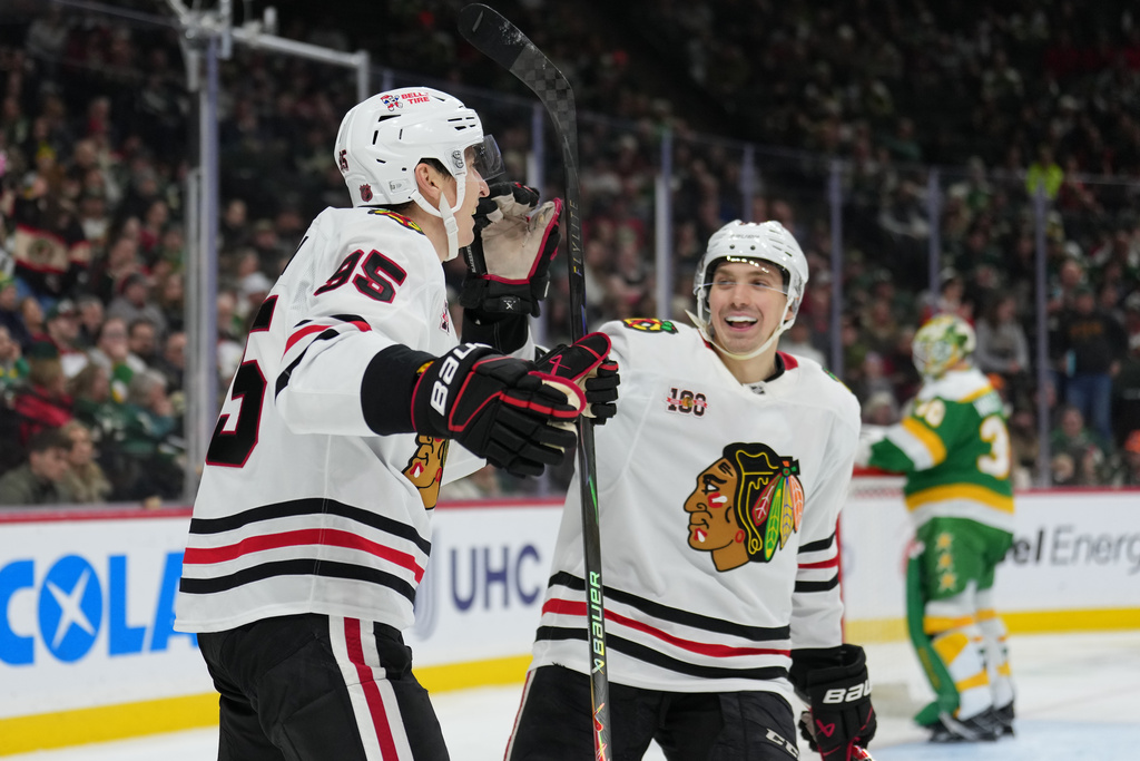 Chicago Blackhawks right wing Ilya Mikheyev (95), left, celebrates with defenseman Artyom Levshunov (55) after scoring a goal during the second period of an NHL hockey game against the Minnesota Wild, Tuesday, Jan. 27, 2026, in St. Paul, Minn. (AP Photo/Abbie Parr)