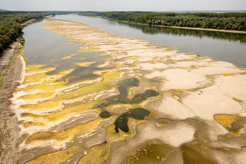 Usually submerged areas of the Danube River are exposed amid exceptionally low water levels, in Rasova, Romania, Monday, Aug. 3 2026. (AP Photo/ Vadim Ghirda)