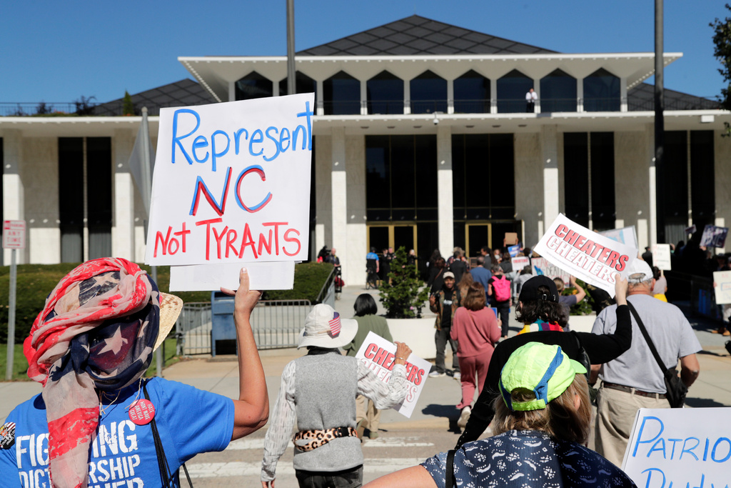 FILE - Demonstrators approach the Legislative Building during a rally protesting a proposed election redistricting map, Oct. 21, 2025, in Raleigh, N.C. (AP Photo/Chris Seward)